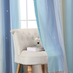 Detail of gradient rainbow curtains with star cutouts and white sheer lace overlay