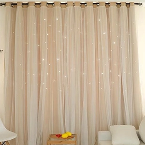 Detailed view of double-layer blackout curtain with hollow star cutouts and white tulle