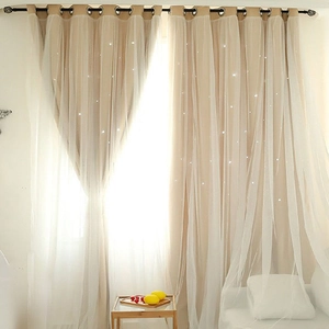 Detail of double-layer cutout star curtains with beige blackout fabric and sheer white lace