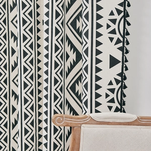 Detail of bohemian black and white geometric print curtain with black tassel fringe