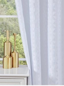 Detail of white modern curtains with geometric jacquard pattern for balcony shading