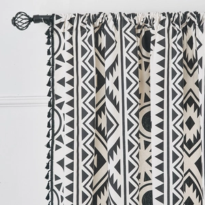 Detail of bohemian black and white geometric pattern curtain with black tassel fringe