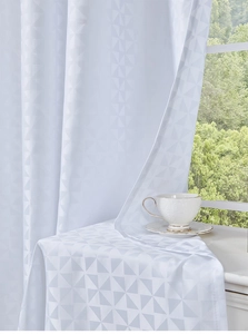Detail of white outdoor curtain showing geometric triangle jacquard texture and thick fabric