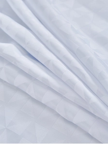 Close-up of white outdoor curtain fabric showing geometric jacquard texture and sheen