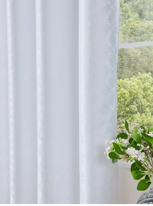Detailed macro view of white waterproof curtain featuring elegant leaf pattern textures