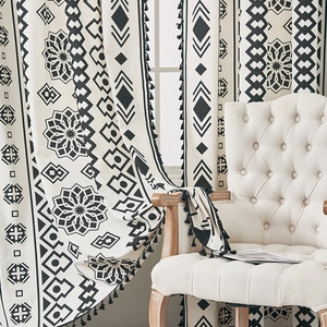 Bohemian black and white geometric print curtains with elegant black tassel trim details