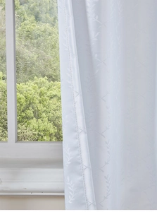 Close-up of white waterproof outdoor curtain with elegant jacquard leaf pattern detail