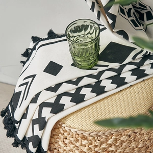 Detail of bohemian black and white geometric cotton linen curtain with handmade tassels