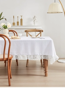 Detail van wit jacquard tafelkleed met elegante kanten rand voor modern interieur