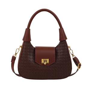 Dark brown woven crescent bag with golden twist lock and adjustable crossbody strap