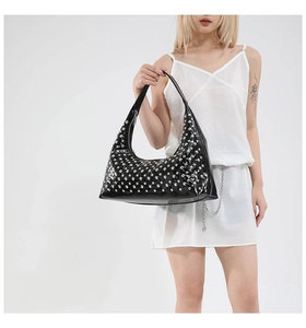 Black patent leather crescent bag with silver rivet studs and punk style details