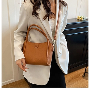 Brown litchi grain leather bucket bag with top handles and detachable shoulder strap
