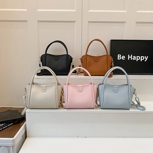 Minimalist bucket bag with top handle and shoulder strap in five assorted colors
