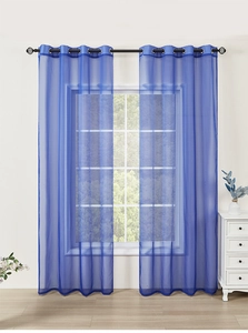 Detail of dark blue sheer curtains with metal grommet top hanging on a large window