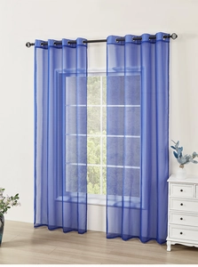 Detail of navy blue voile curtains with metal grommets hanging on a modern window