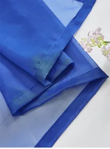 Close-up of semi-transparent blue chiffon sheer fabric with fine mesh texture and soft folds