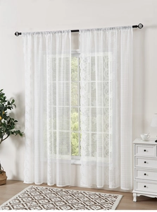 Detail of white French lace sheer curtain with floral patterns and scalloped edges