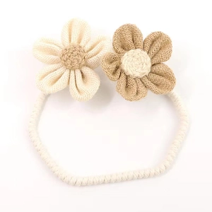 Detailed view of handmade rustic floral curtain tieback with woven fabric flowers