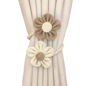 Floral jute curtain tiebacks in natural brown and cream white with braided linen rope