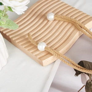 Detail of creative flower curtain tieback with cream braided rope and elegant pearls