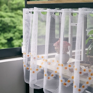 Detail of white lace cafe curtain with yellow daisy embroidery and rod pocket top design