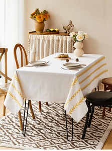 Detail of Nordic rectangular tablecloth with yellow embroidery and cotton-linen texture