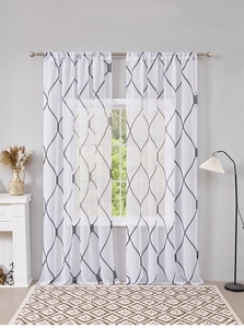 Detail view of semi-sheer white curtains with gray geometric grid pattern and rod pocket top