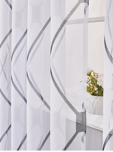 Macro detail of Nordic semi-transparent window curtain with grey geometric trellis patterns