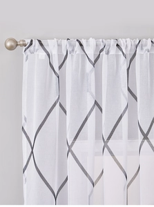 Detail of translucent white lattice curtain with dark grey geometric diamond pattern