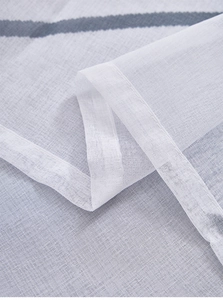 Close-up of white sheer curtain fabric with dark grey twill pattern and fine grid mesh
