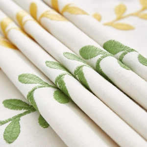 Nordic style linen tablecloth with embroidered yellow leaves and natural texture