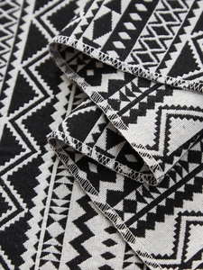 Detailed macro view of woven table runner texture and durable white double-stitched edges