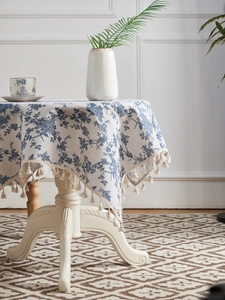 Close-up of French vintage floral round tablecloth with elegant tassel fringe details