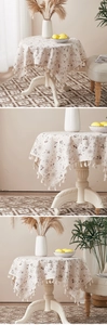 Detail view of cotton linen tablecloth with floral patterns, dragonflies and tassel edges