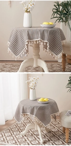 Close-up of brown checkered cotton linen tablecloth with white decorative tassels
