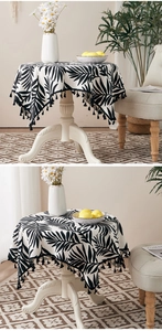 Close-up of tropical leaf pattern and tassel edge on round cotton linen tablecloth