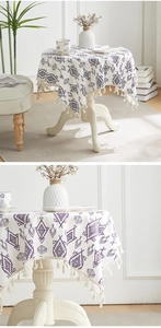 Detail of cotton linen tablecloth with purple geometric diamond patterns and fringe trim
