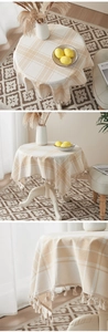 Detailed view of beige cotton linen tablecloth with classic plaid pattern and fringe tassel edge