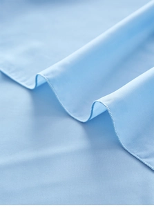 Detail of light blue chiffon table runner showing fine stitching and soft fabric texture