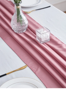 Detail of pink chiffon table runner showing soft texture and fine edge stitching