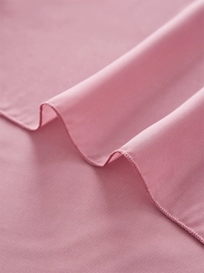 Close-up of soft pink chiffon table runner featuring high-quality hemmed edge stitching