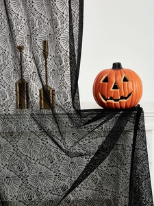 Detailed view of Halloween black lace curtain with spooky spider web hollow patterns