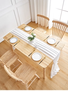 Detail of white pleated chiffon table runner showing elegant vertical fabric texture
