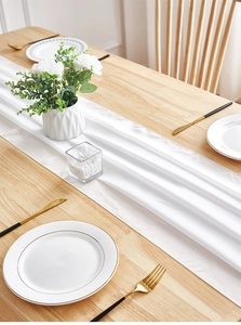 Detail of white chiffon table runner showing smooth satin texture and elegant drapery
