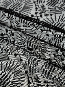 Detailed close-up of Halloween lace curtain with intricate floral patterns and mesh texture
