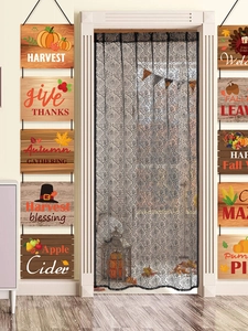 Detail of black lace door curtain with intricate floral cutouts for Halloween decor