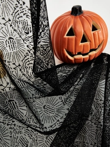 Detail of black spiderweb lace fabric with mesh texture for Halloween party decorations