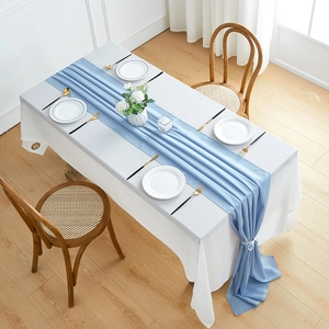 Elegant Morandi blue chiffon table runner draped over a rectangular white tablecloth