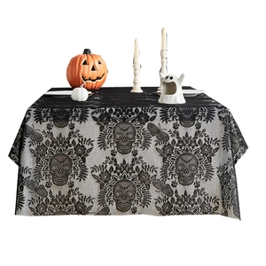Halloween black lace tablecloth with skull and floral patterns on a festive table