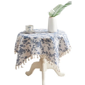 Floral cotton linen round tablecloth with fringe tassels on white wooden table